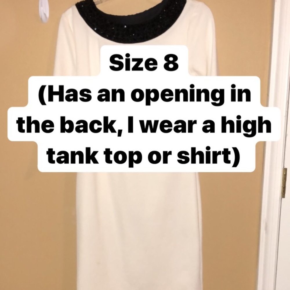 White dress with a Gem neck line.
